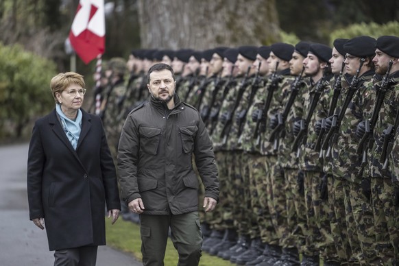 Swiss Federal President Viola Amherd, left, and her guest, Volodymyr Zelenskyy, right, President of Ukraine, inspect the guard of honour in Kehrsatz near Bern, Switzerland, Monday, Jan. 15, 2024. Zele ...