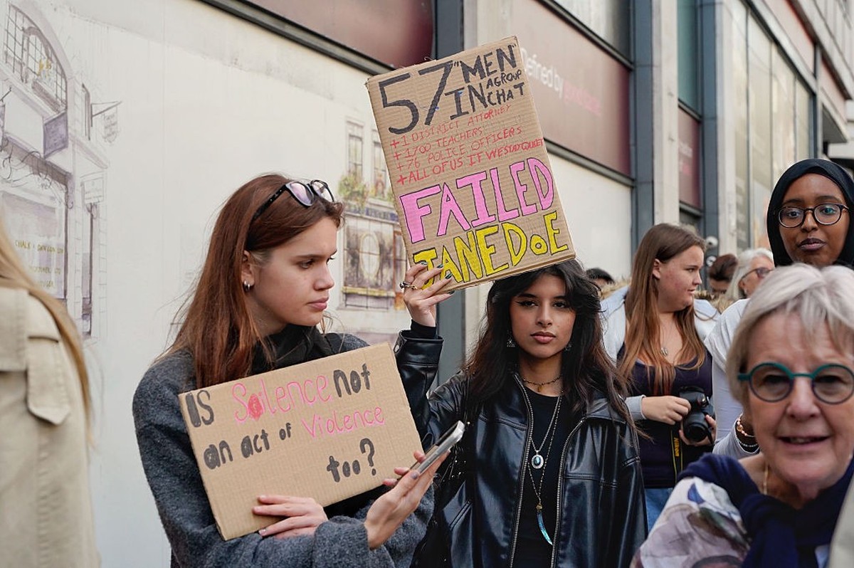 LONDON, ENGLAND - OCTOBER 14: A woman holds a hand made sign referencing a group chat where men could have stood up for the woman at the centre of the Cornell University law suit at Leicester Square o ...