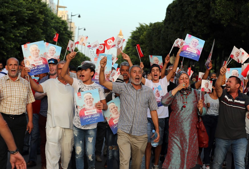 epa07840774 Supporters of Abdelfattah Mourou, vice-president of the Islamist party Ennahda, and presidential candidate cheer during the last day of the presidential campaign in Tunis, Tunisia, 13 Sept ...