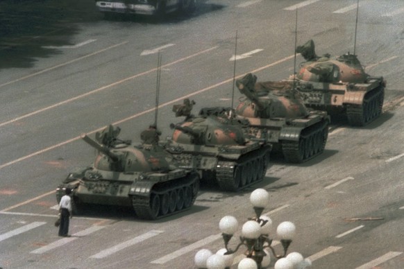 FILE - In this June 5, 1989 file photo, a Chinese man stands alone to block a line of tanks heading east on Beijing&#039;s Changan Blvd. from Tiananmen Square in Beijing. A quarter century after the C ...