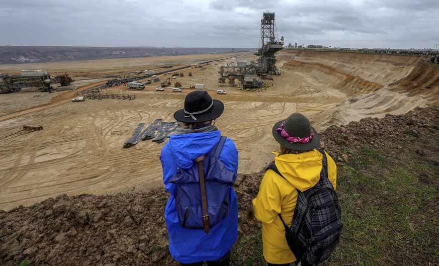 People attend a protest rally at the Garzweiler opencast mining near the village Luetzerath in Erkelenz, Germany, Saturday, Jan. 14, 2023. Swedish climate campaigner Greta Thunberg takes part in that  ...