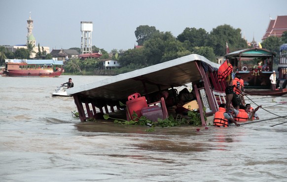 Thai rescue teams search for victims after a boat capsized at Chao Phraya River in Ayuthaya Province, Thailand, Sunday, Sept. 18, 2016. Thai news reports say at least 13 people were killed when a doub ...