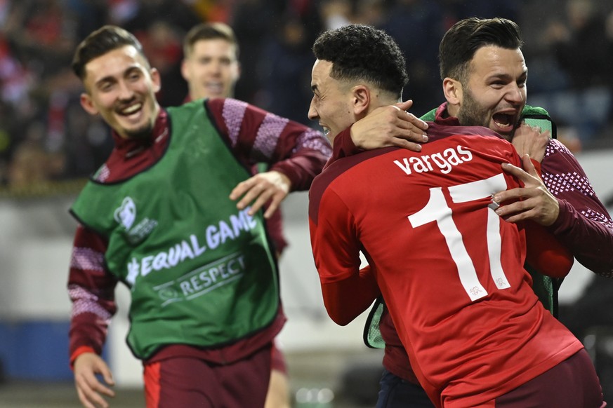 Switzerland's midfielder Ruben Vargas, center, celebrates his goal after scoring the 2 - 0 with Switzerland's midfielder Renato Steffen, right, ans Switzerland's forward Andi Zeqiri, le ...