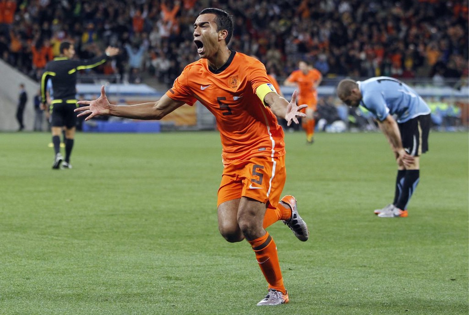 Netherlands&#039; Giovanni van Bronckhorst celebrates after scoring the 1-0 during the 2010 FIFA soccer World Cup semi-final soccer match between Uruguay and the Netherlands at the Green Point Stadium ...