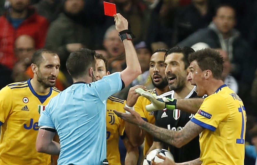 Referee Michael Oliver shows a red car to Juventus goalkeeper Gianluigi Buffon during a Champions League quarter final second leg soccer match between Real Madrid and Juventus at the Santiago Bernabeu ...