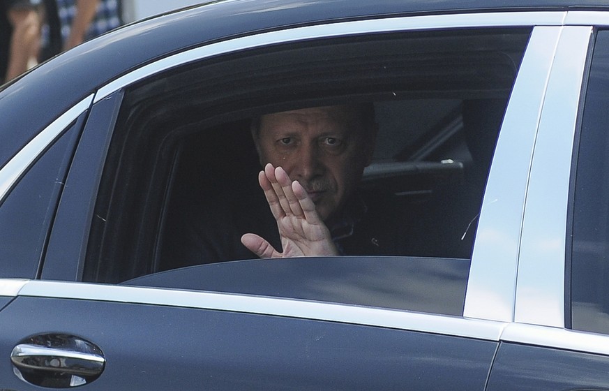Turkish President Recep Tayyip Erdogan waves from his car after leaving his residence in Istanbul to attend a funeral service for the victims of a thwarted coup at Fatih mosque in Istanbul, Turkey, Ju ...