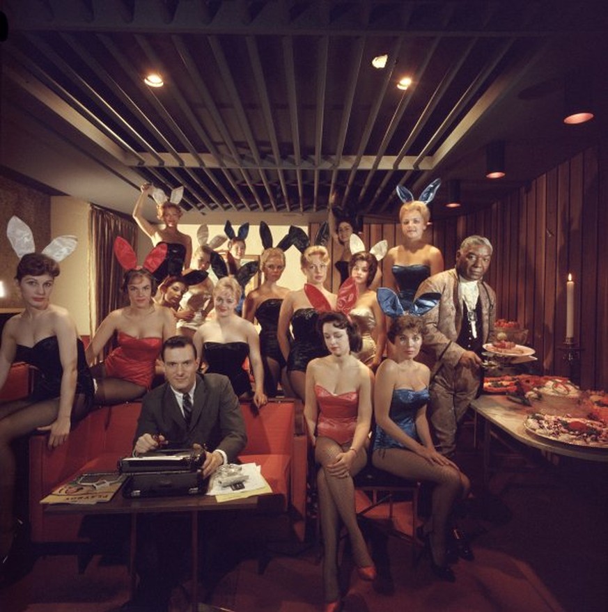 Working at his typewriter surrounded by &#039;bunny girls&#039;, publisher Hugh M Hefner at the Playboy Key Club in Chicago. He founded adult magazines, Playboy, VIp and Oui. (Photo by Slim Aarons/Get ...
