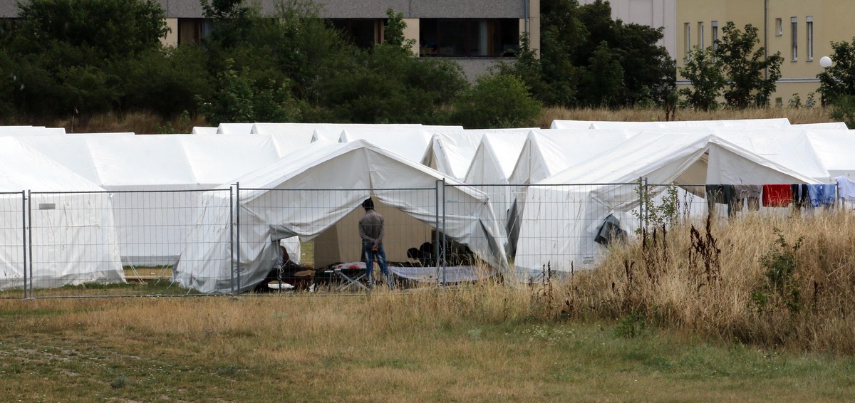 Tents for refugees are set up at the refugee camp in Traiskirchen, Austria, Friday, July 31, 2015. Austrias federal government plans to change the constitution in attempts to end a standoff with prov ...
