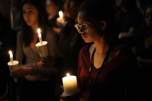 Natalynn Rivis, a student at University of Nevada Las Vegas, right, takes part in a vigil Monday, Oct. 2, 2017, in Las Vegas. A gunman on the 32nd floor of the Mandalay Bay casino hotel rained automat ...