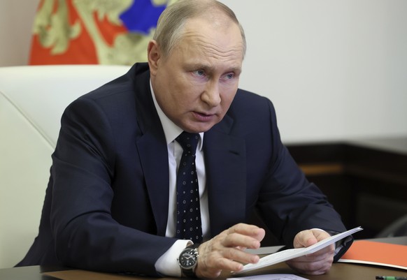 FILE - Russian President Vladimir Putin chairs a meeting with members of the Security Council via teleconference call at the Novo-Ogaryovo state residence outside Moscow, Russia, on May 20, 2022. Russ ...