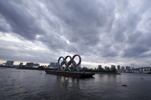 FILE - This April 12, 2021, file photo shows the Olympic rings floating in the water in the Odaiba section in Tokyo. Some nurses in Japan are incensed at a request from Tokyo Olympic organizers to hav ...