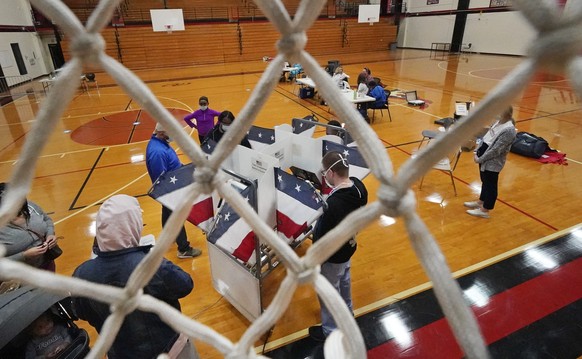 People vote in the gymnasium at Pearl-Cohn Magnet High School on Election Day Tuesday, Nov. 3, 2020, in Nashville, Tenn. (AP Photo/Mark Humphrey)