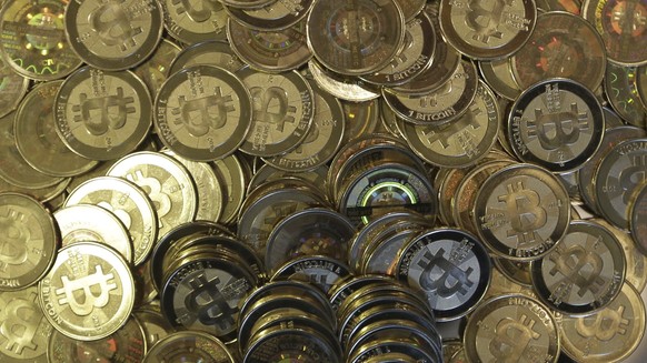 FILE - This April 3, 2013 photo shows bitcoin tokens at software engineer Mike Caldwell&#039;s shop in Sandy, Utah. The Federal Reserve Board has denied a Wyoming cryptocurrency bank&#039;s applicatio ...