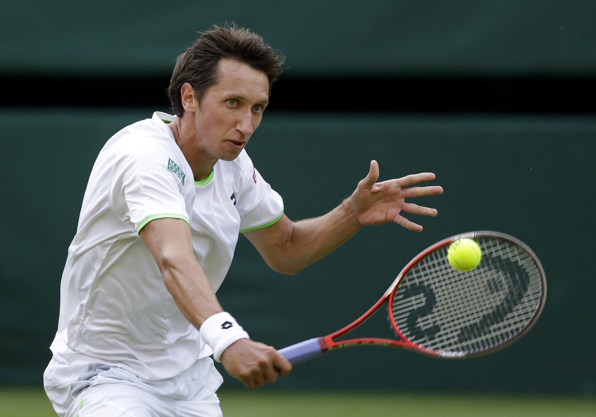 Sergiy Stakhovsky of Ukraine plays a return to Roger Federer of Switzerland during their Men's second round singles match at the All England Lawn Tennis Championships in Wimbledon, London, Wednes ...
