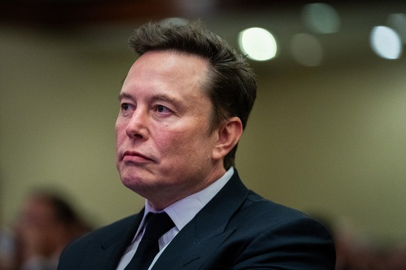 epa11718840 Elon Musk listens as US President-elect Donald Trump speaks during a meeting with House Republicans at the Hyatt Regency hotel in Washington, DC, USA, 13 November 2024. EPA/ALLISON ROBBERT ...