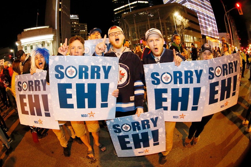 Winnipeg Jet fans celebrate at Portage and Main in downtown Winnipeg, Manitoba, after the Winnipeg Jets defeated the Minnesota Wild 5-0 in Game 5 of an NHL hockey first-round playoff series in Winnipe ...