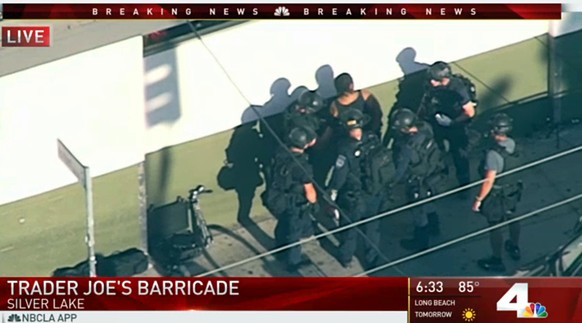 In this image from video provided by KNBC-TV, officers take a suspect into custody outside a Trader Joe&#039;s supermarket in the Silver Lake district of Los Angeles Saturday, July 21, 2018. (KNBC-TV  ...
