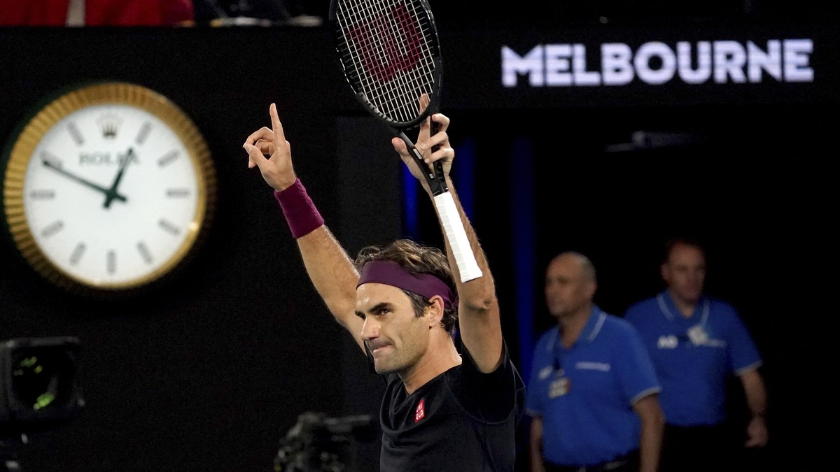 Switzerland's Roger Federer celebrates after defeating Australia's John Millman in their third round match at the Australian Open tennis championship in Melbourne, Australia, Saturday, Jan.  ...
