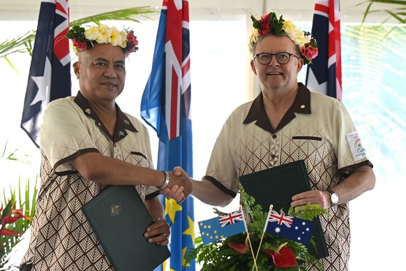 epa11568075 Australian Prime Minister Anthony Albanese shakes hands with Prime Minister of Tuvalu Feleti Teo (L) after signing agreements for the Australia-Tuvalu Falepili Union to come into force at  ...