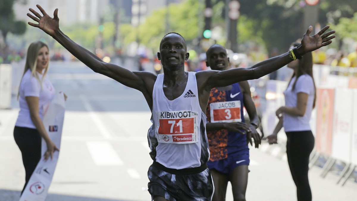 Kenya's Kibiwott Kandie celebrates after crossing the finish line ahead of Uganda's Jacob Kiplimo during the Sao Silvestre race in Sao Paulo, Brazil, Tuesday, Dec. 31, 2019. (AP Photo/Nelson ...
