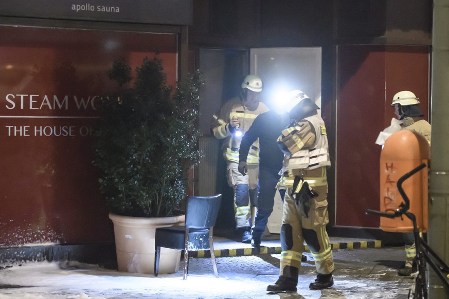 epa05773925 Firemen come out of a sauna club, where a fire took place, in Berlin, Germany, 06 February 2017. According to reports, three people died in a fire at the sauna club. The cause of the incid ...