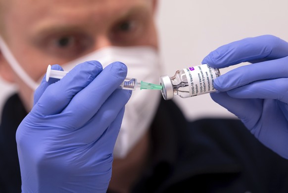 FILE - In this March 2, 2021 file photo, an employee prepares AstraZeneca&#039;s Corona vaccine for vaccination at the police vaccination center in Munich, Germany. The German government says it is su ...