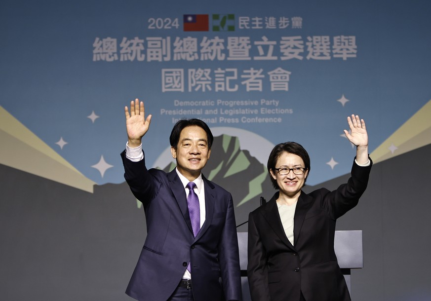 epa11073412 Taiwan's vice president and ruling Democratic Progressive Party (DPP) presidential candidate William Lai Ching-te (L) and vice presidential candidate Hsiao Bi-khim wave after winning the...