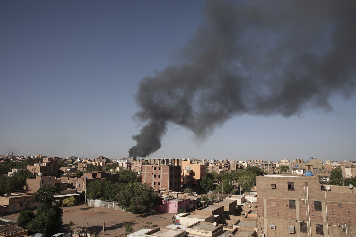 FILE - Smoke is seen in Khartoum, Sudan, Wednesday, April 19, 2023. Warring factions trying to seize control of the east African nation of Sudan have plunged the country into chaos, and thousands are  ...