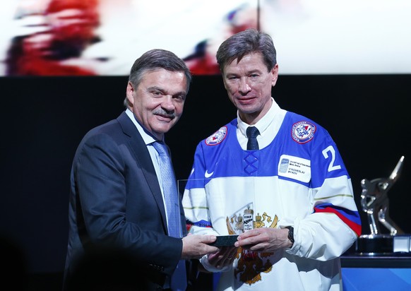 A former Russian hockey player Vyacheslav &quot;Slava&quot; Bykov, right, and International Ice Hockey Federation President, Rene Fazel pose for press during &quot;Hall of Fame Induction Ceremony 2014 ...