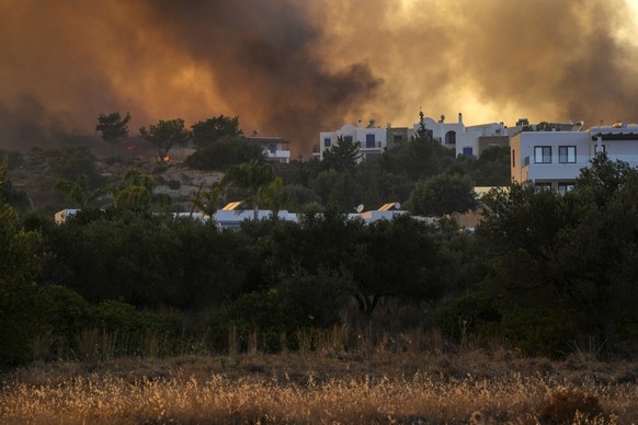 A wildfire burns in Gennadi village, on the Aegean Sea island of Rhodes, southeastern Greece, on Tuesday, July 25, 2023. A firefighting plane has crashed in southern Greece, killing both crew members, ...