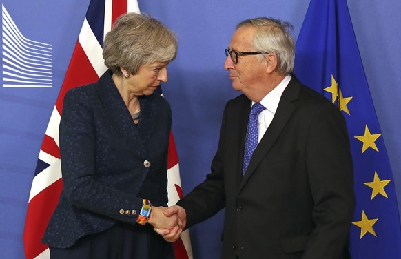 European Commission President Jean-Claude Juncker shakes hands with British Prime Minister Theresa May before their meeting at the European Commission headquarters in Brussels, Thursday, Feb. 7, 2019. ...