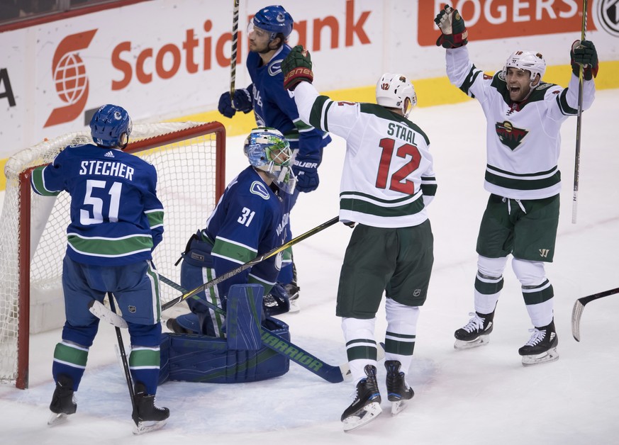 Minnesota Wild center Eric Staal (12) celebrates his goal past Vancouver Canucks goaltender Anders Nilsson (31) as Wild left wing Jason Zucker (16) and Canucks defensemen Troy Stecher (51) and Michael ...