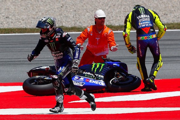 epa07652082 Italian of Monster Energy Yamaha Valentino Rossi (R) and his Spanish teammate Maverick Vinales (L) crash during the Motorcycling Grand Prix of Catalunya at the Circuit de Barcelona-Catalun ...