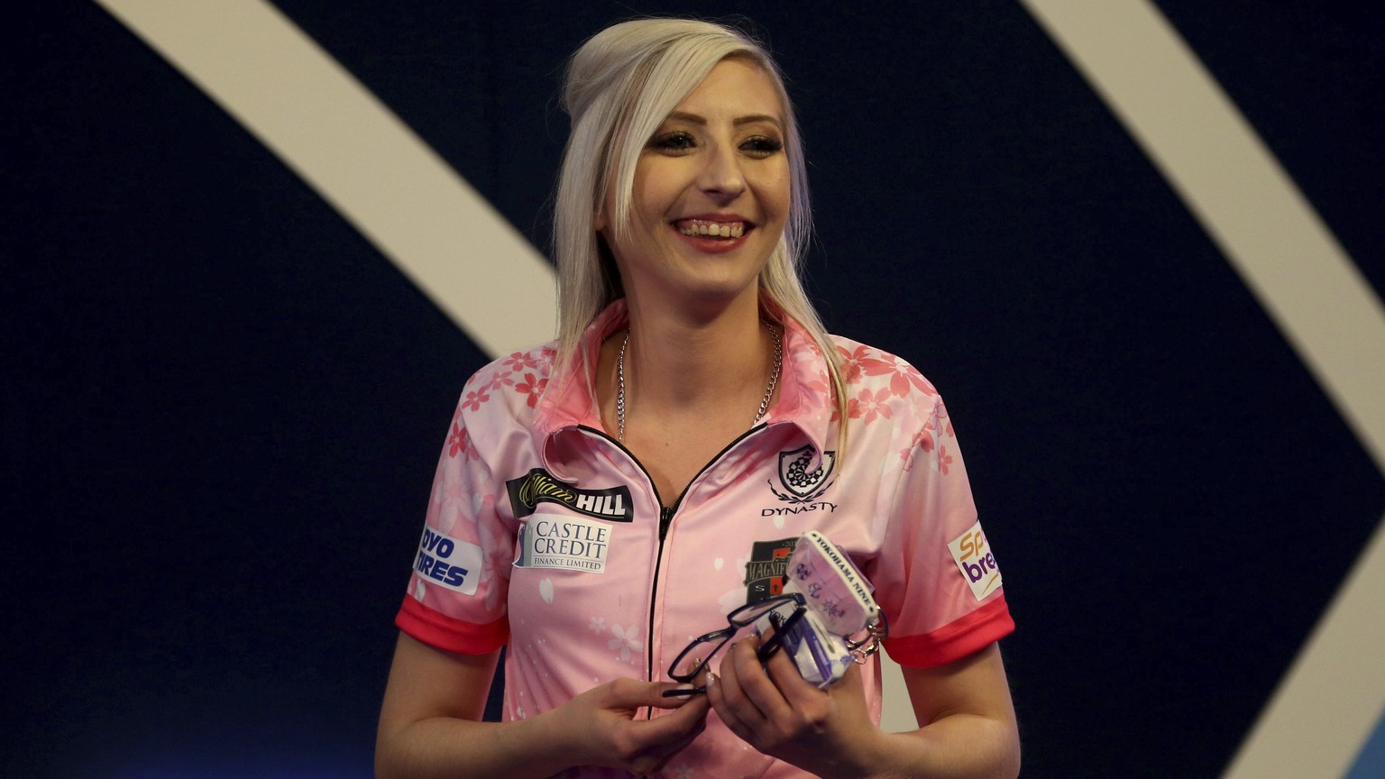 Fallon Sherrock celebrates after beating Mensur Suljovic during their match on day nine of the William Hill World Championships at Alexandra Palace, London, Saturday Dec. 21, 2019. (Steven Paston/PA v ...