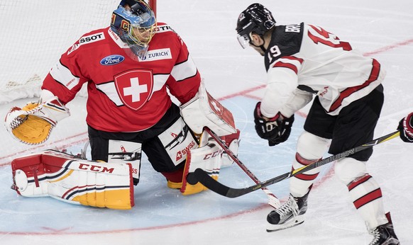 Switzerland’s goaltender Jonas Hiller, left, fights for the puck against Canada&#039;s Gilbert Brule during the 2017 Karjala Cup ice hockey match between Switzerland and Canada in the Tissot Arena in  ...