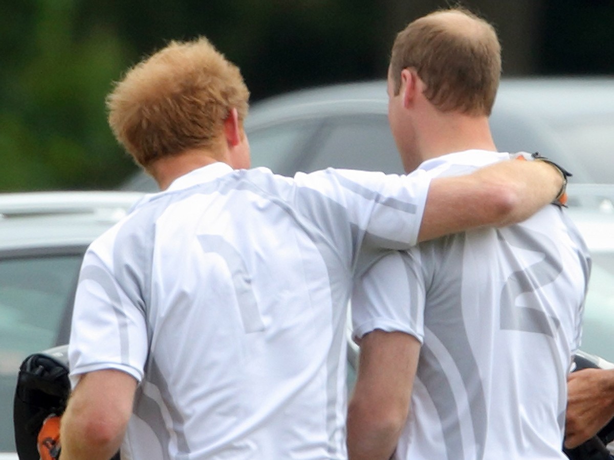 ASCOT, UNITED KINGDOM - MAY 31: (EMBARGOED FOR PUBLICATION IN UK NEWSPAPERS UNTIL 48 HOURS AFTER CREATE DATE AND TIME) Prince Harry and Prince William, Duke of Cambridge embrace as they attend day 2 o ...