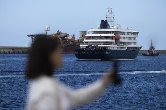 epa12947353 MV Hondius is seen at the port in Granadilla de Abona, Tenerife, Canary Islands, Spain, 11 May 2026, as Spanish authorities hold a press conference to provide updates on the evacuation of  ...