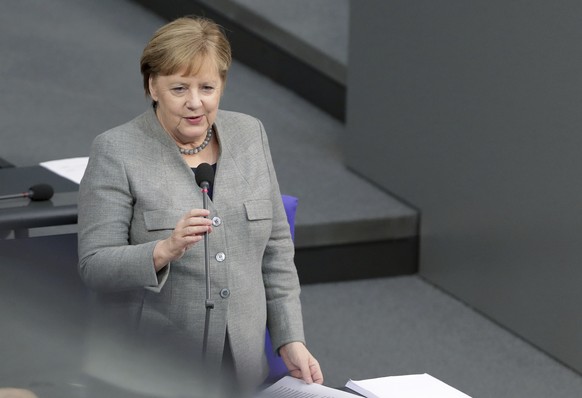 German Chancellor Angela Merkel takes questions as part of a meeting of the German parliament, Bundestag, at the Reichstag building in Berlin, Germany, Wednesday, Dec. 18, 2019. (AP Photo/Michael Sohn ...