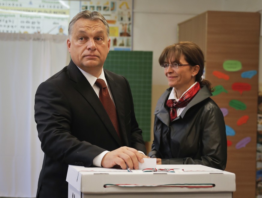 Hungarian Prime Minister Viktor Orban casts his vote in the referendum as his wife Aniko Levai stands by in Budapest, Hungary, Sunday, Oct. 2, 2016. Hungarians vote in a referendum which Prime Ministe ...