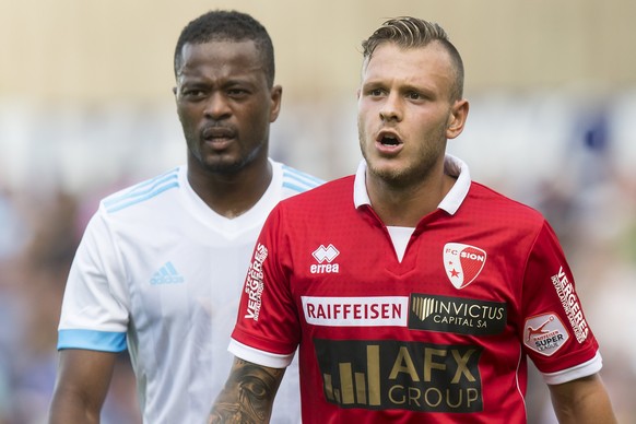 epa06068175 Sion&#039;s Federico Dimarco (R) reacts next to Marseille&#039; Patrice Evra during a friendly soccer match between FC Sion from Switzerland and Olympique de Marseille from France at the S ...