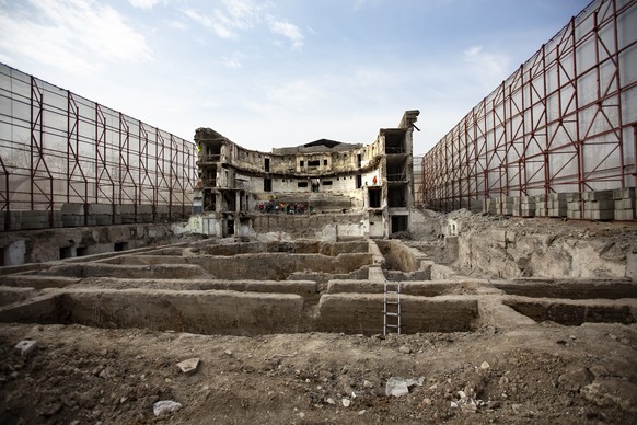 Construction workers clean up the remaining part of the Mariupol&#039;s theater to use it in the construction of a new theater in Mariupol, in Russian-controlled Donetsk region of eastern Ukraine, Tue ...