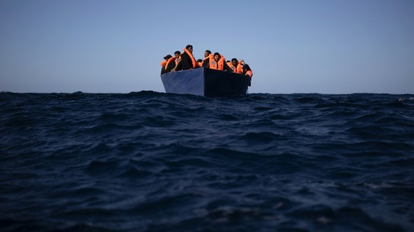 Migrants from Eritrea, Egypt, Syria and Sudan, wait to be assisted by aid workers of the Spanish NGO Open Arms, after fleeing Libya on board a precarious wooden boat in the Mediterranean sea, about 11 ...