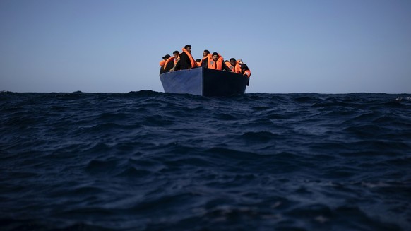 Migrants from Eritrea, Egypt, Syria and Sudan await help from aid workers from Spanish NGO Open Arms, after fleeing Libya aboard a precarious wooden boat in the Mediterranean Sea, about 11…