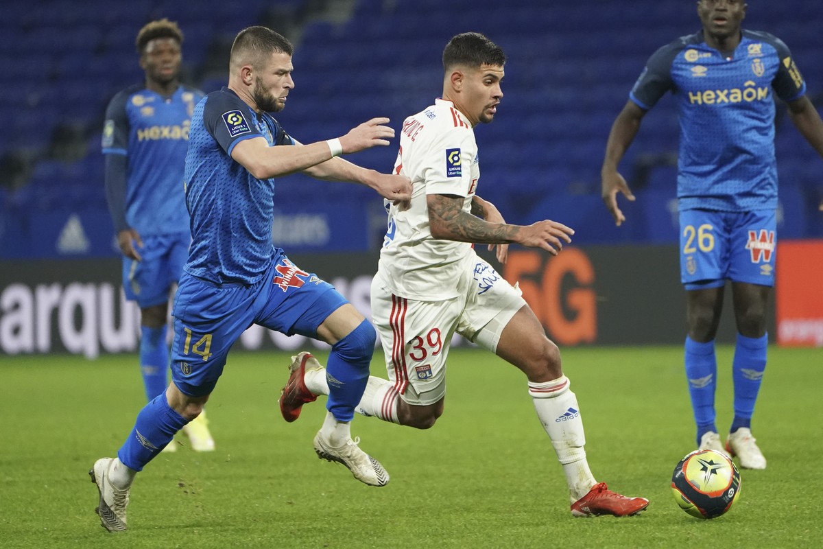 Reims' Valon Berisha, left, and Lyon's Bruno Guimaraes fight for the ball during the French League One soccer match between Lyon and Reims, at the Groupama stadium in Lyon, France, Wednesday ...