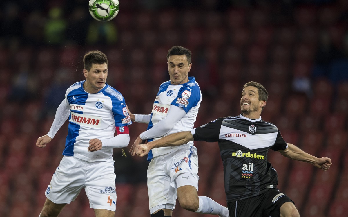 Grasshoppers Milan Vilotic, links, und Marko Basic, Mitte, spielt um den Ball gegen Luganos Fulvio Sulmoni, rechts, im Fussball Meisterschaftsspiel der Super League zwischen dem Grasshopper Club Zueri ...