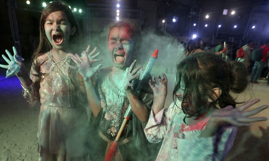 Young girls from the Pakistani Hindu community play with color to celebrate Holi, the festival of colors, in Karachi, Pakistan, Thursday, March 17, 2022. Holi festival marks the beginning of spring an ...