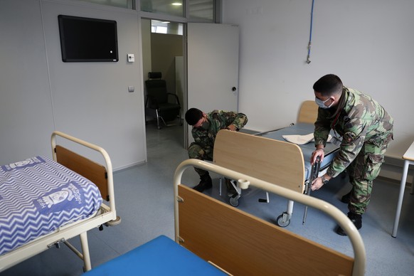 Soldiers prepare beds in a new COVID-19 ward being set up at the Military Hospital in Lisbon, Tuesday, Jan. 26, 2021. The military hospital is expanding it&#039;s number of beds available to take COVI ...