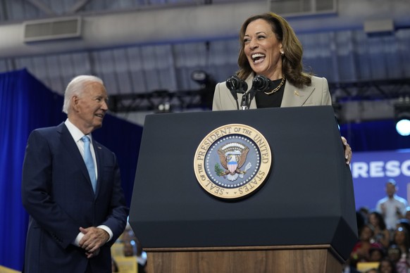 President Joe Biden, left, listens as Democratic presidential nominee Vice President Kamala Harris speaks about the administration&#039;s efforts to lower costs during an event at Prince George&#039;s ...