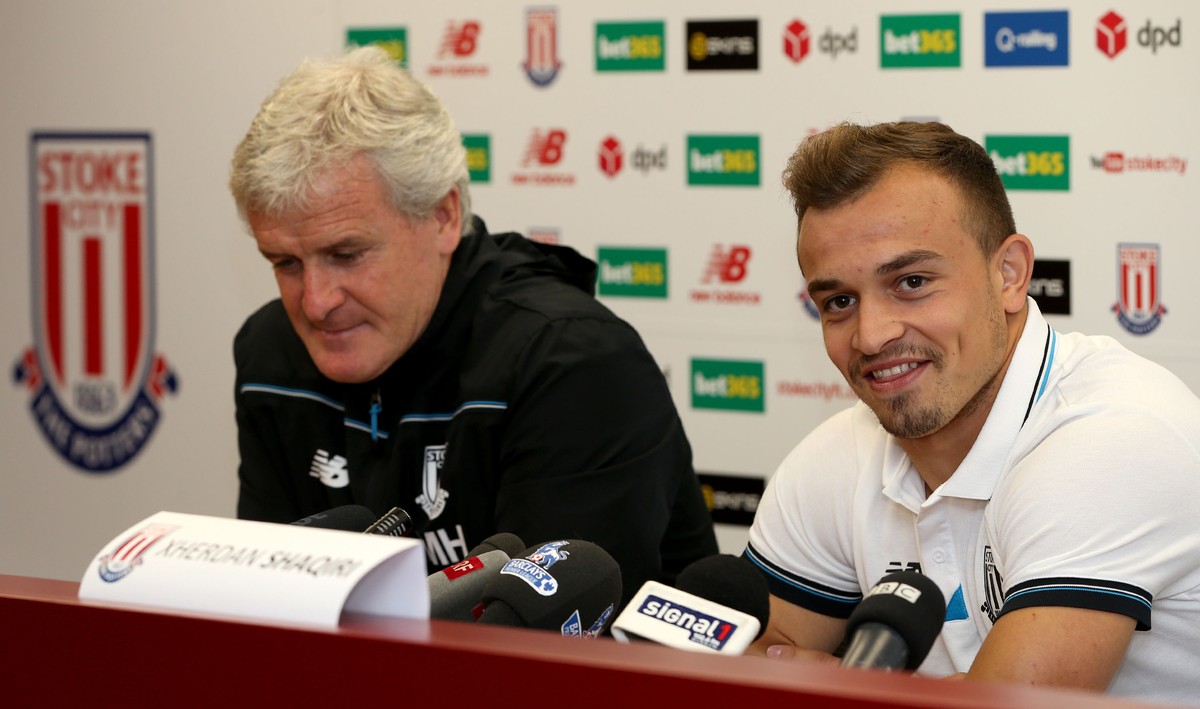 Stoke City's new signing Xherdan Shaqiri, right, attends a press conference with manager Mark Hughes at the Britannia Stadium, Stoke-on-Trent England Thursday Aug. 13, 2015. Stoke has completed t ...