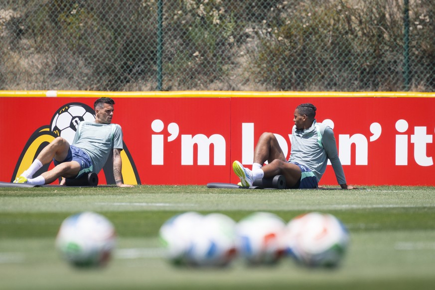 Switzerland's Granit Xhaka, left, and Manuel Akanji exercise stretching during a training session of the Swiss national soccer team at the SDJA in San Diego, California, USA, Monday, June 8, 2026 ...